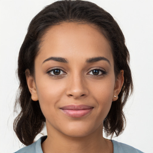 Joyful latino young-adult female with long  brown hair and brown eyes