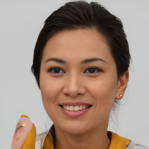 Joyful asian young-adult female with medium  brown hair and brown eyes