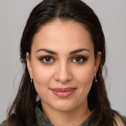 Joyful latino young-adult female with medium  brown hair and brown eyes