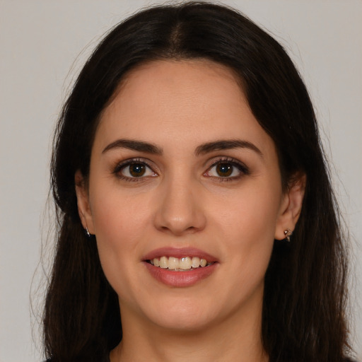 Joyful white young-adult female with long  brown hair and brown eyes