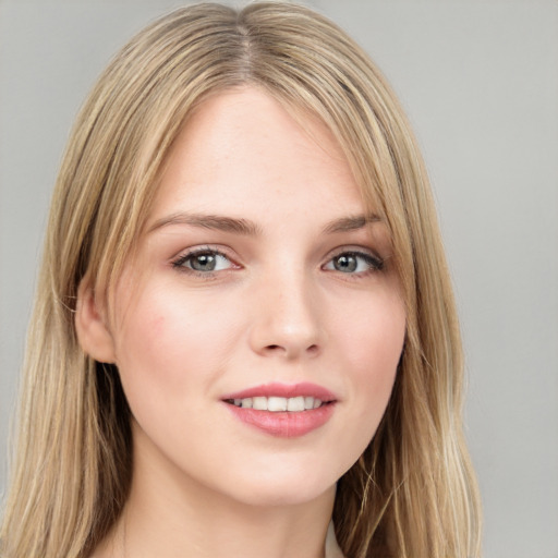 Joyful white young-adult female with long  brown hair and grey eyes