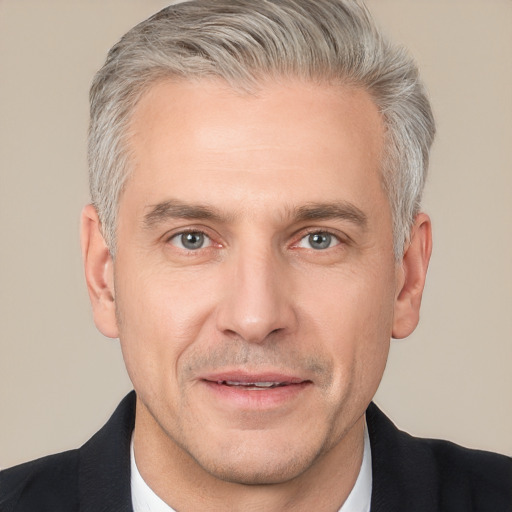 Neutral white adult male with short  gray hair and brown eyes