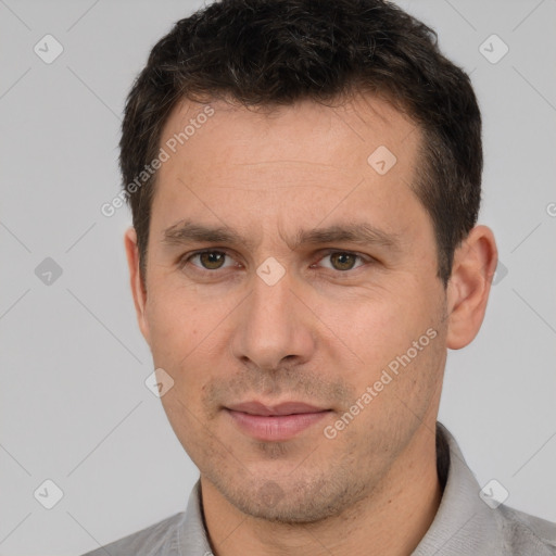 Joyful white adult male with short  brown hair and brown eyes