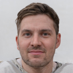 Joyful white adult male with short  brown hair and grey eyes