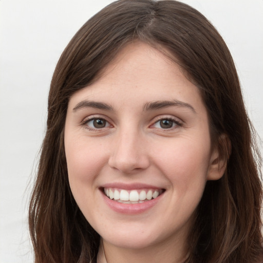 Joyful white young-adult female with long  brown hair and grey eyes