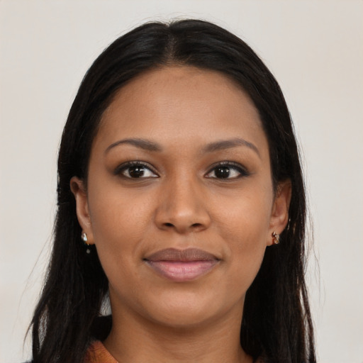 Joyful black young-adult female with long  brown hair and brown eyes