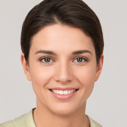 Joyful white young-adult female with short  brown hair and brown eyes