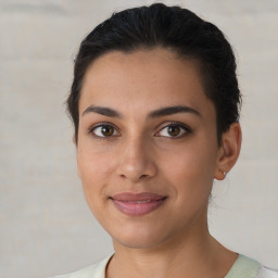 Joyful latino young-adult female with short  brown hair and brown eyes