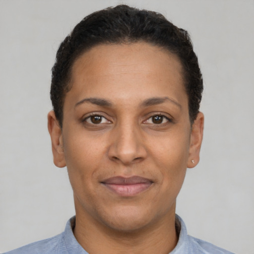 Joyful latino adult female with short  brown hair and brown eyes