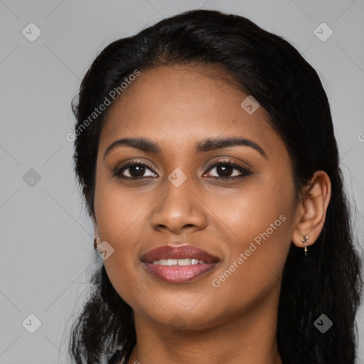 Joyful black young-adult female with long  black hair and brown eyes