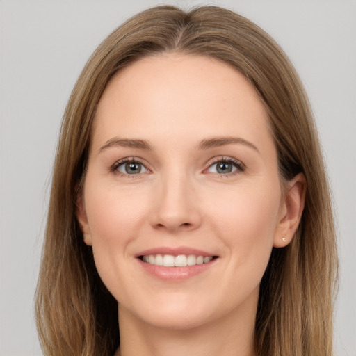 Joyful white young-adult female with long  brown hair and grey eyes