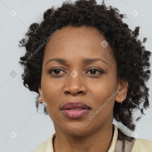 Joyful black adult female with medium  brown hair and brown eyes