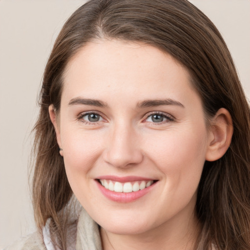 Joyful white young-adult female with long  brown hair and grey eyes