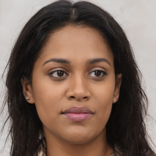 Joyful latino young-adult female with long  brown hair and brown eyes