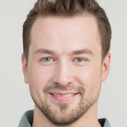 Joyful white young-adult male with short  brown hair and grey eyes