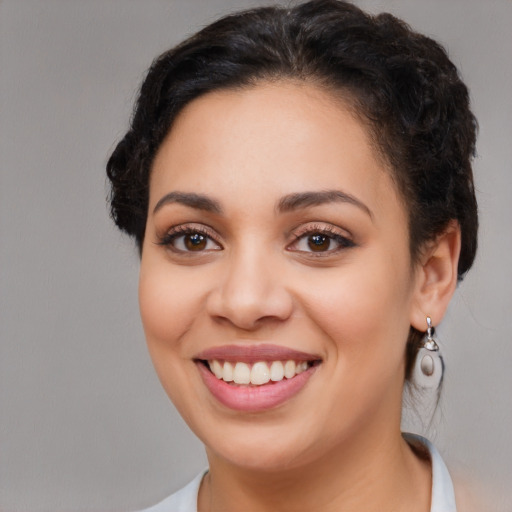 Joyful latino young-adult female with medium  brown hair and brown eyes
