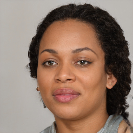 Joyful black young-adult female with medium  black hair and brown eyes