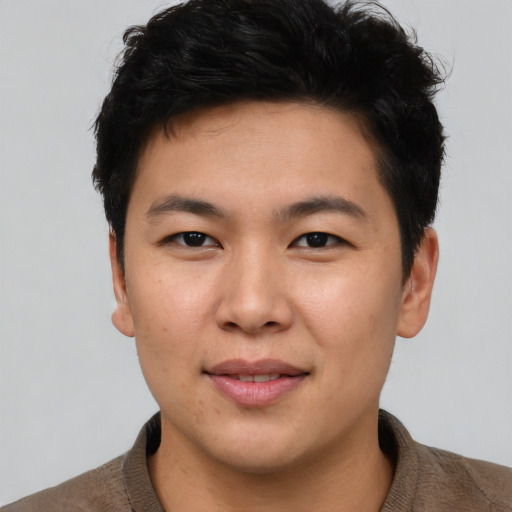 Joyful asian young-adult male with short  brown hair and brown eyes