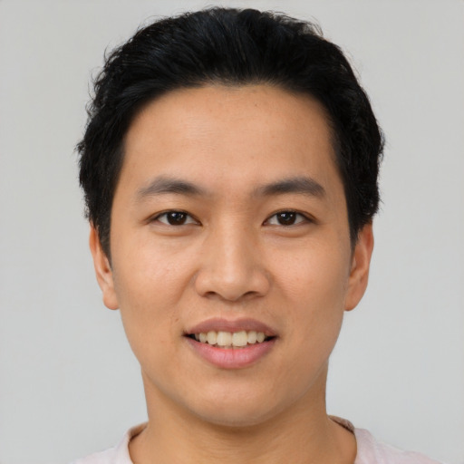 Joyful asian young-adult male with short  black hair and brown eyes