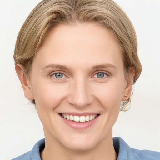 Joyful white young-adult female with medium  brown hair and blue eyes