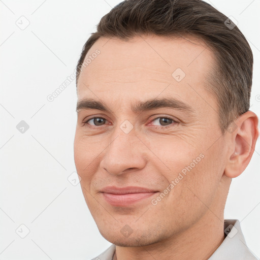 Joyful white young-adult male with short  brown hair and brown eyes