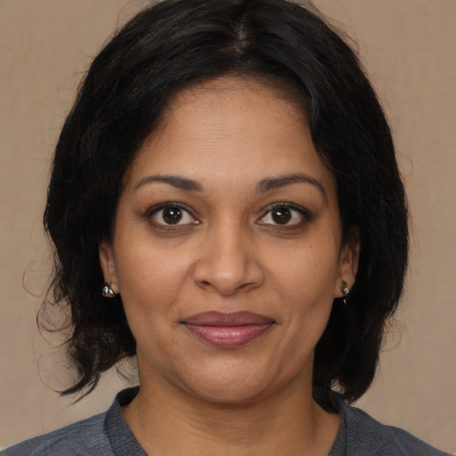 Joyful black young-adult female with medium  brown hair and brown eyes