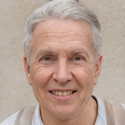 Joyful white middle-aged male with short  gray hair and brown eyes