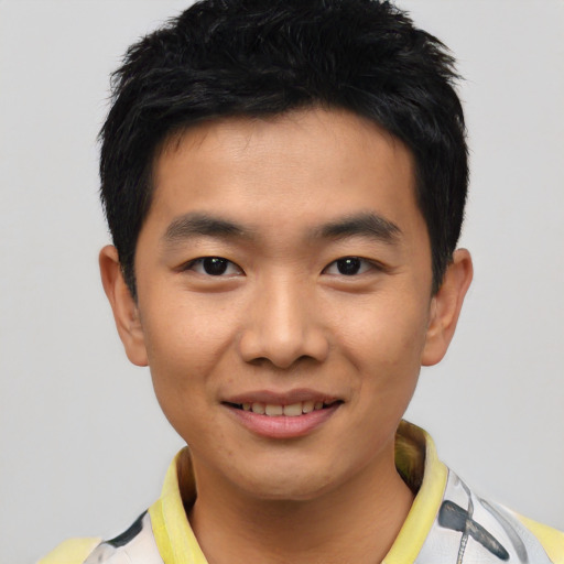 Joyful asian young-adult male with short  black hair and brown eyes