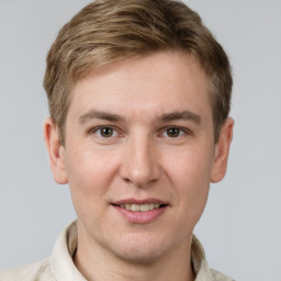 Joyful white young-adult male with short  brown hair and grey eyes