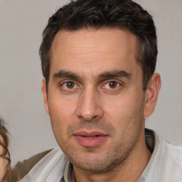 Joyful white adult male with short  brown hair and brown eyes