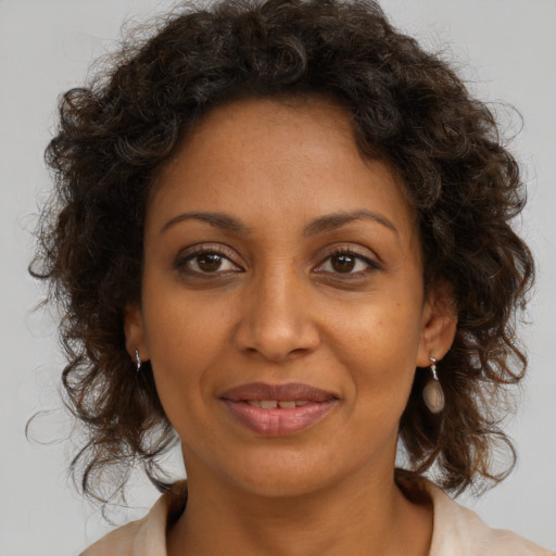 Joyful black young-adult female with medium  brown hair and brown eyes