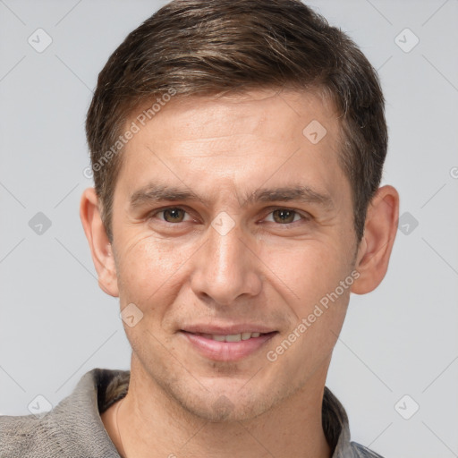 Joyful white adult male with short  brown hair and brown eyes