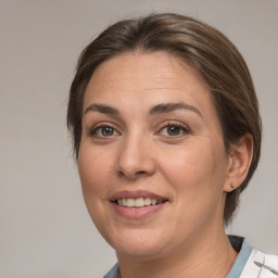 Joyful white adult female with medium  brown hair and brown eyes