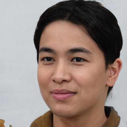 Joyful asian young-adult male with short  black hair and brown eyes