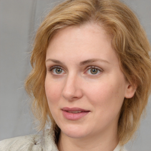 Joyful white young-adult female with medium  brown hair and blue eyes