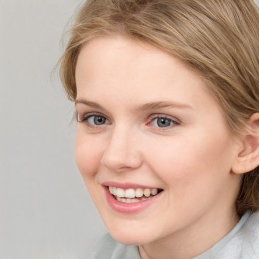 Joyful white young-adult female with medium  brown hair and blue eyes