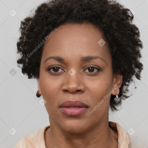 Joyful black adult female with short  black hair and brown eyes