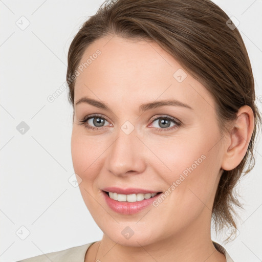 Joyful white young-adult female with medium  brown hair and blue eyes