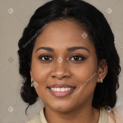 Joyful black young-adult female with long  brown hair and brown eyes