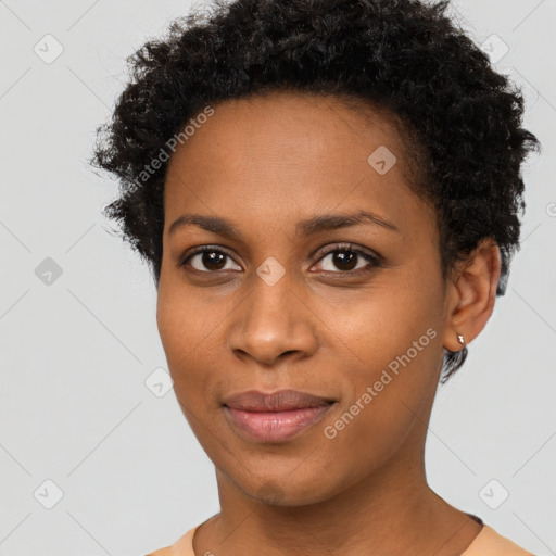 Joyful black young-adult female with short  brown hair and brown eyes