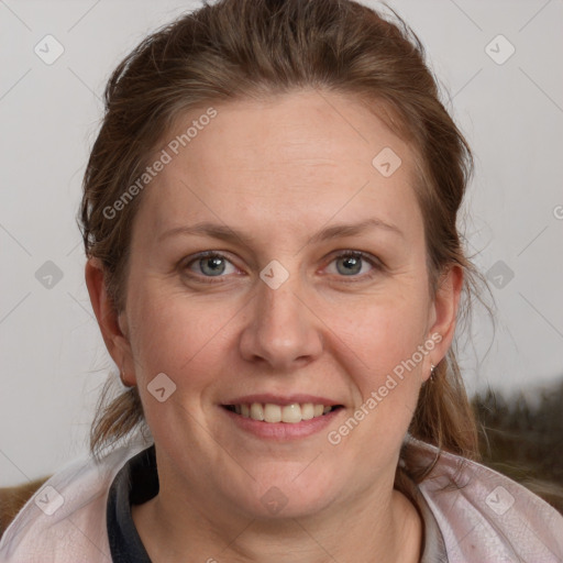 Joyful white adult female with medium  brown hair and blue eyes