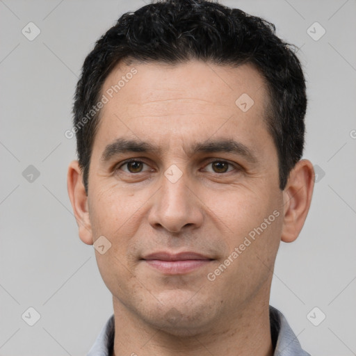 Joyful white young-adult male with short  black hair and brown eyes