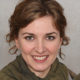 Joyful white young-adult female with medium  brown hair and blue eyes