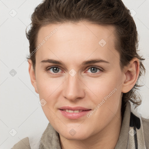 Joyful white young-adult female with short  brown hair and grey eyes