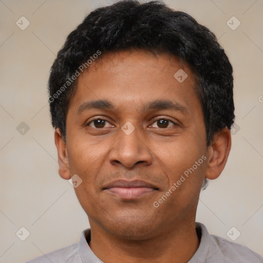 Joyful latino adult male with short  black hair and brown eyes