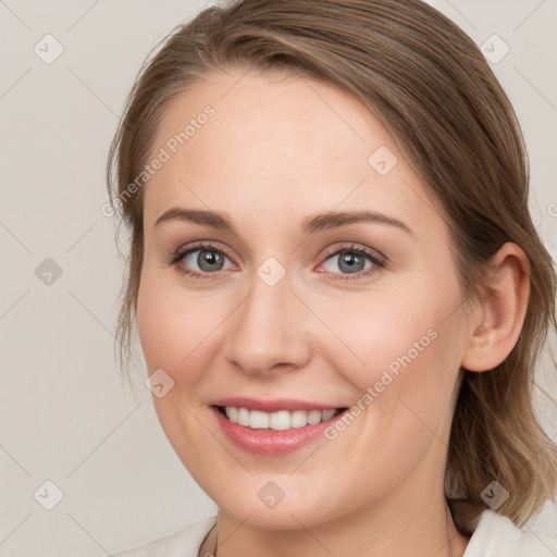 Joyful white young-adult female with medium  brown hair and blue eyes