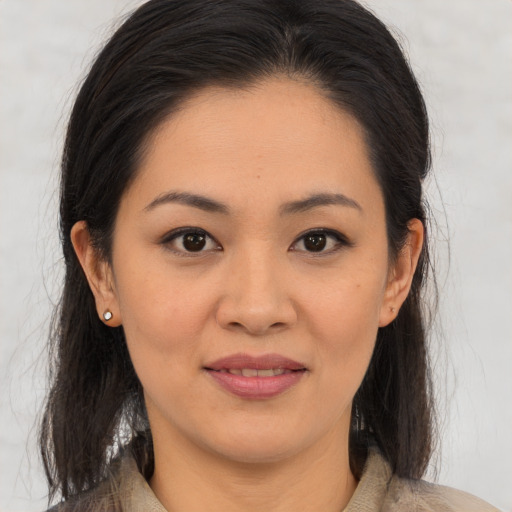 Joyful asian young-adult female with medium  brown hair and brown eyes