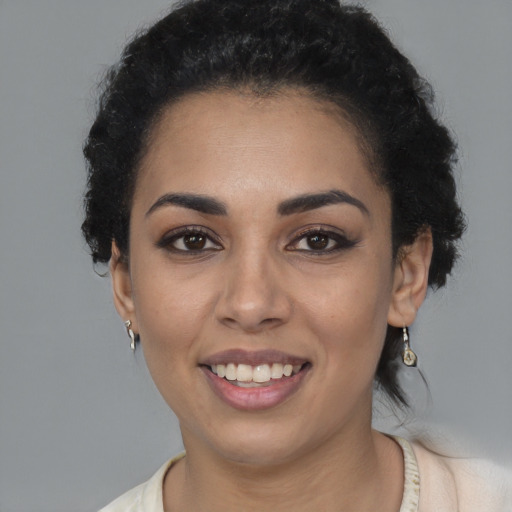 Joyful latino young-adult female with medium  black hair and brown eyes