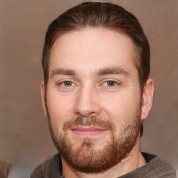 Joyful white adult male with short  brown hair and brown eyes