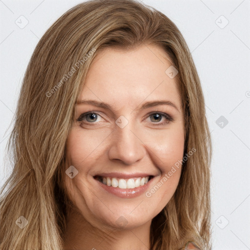 Joyful white young-adult female with long  brown hair and green eyes